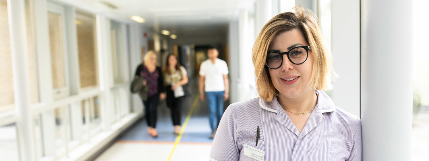 Female nurse stood in a hospital corridor